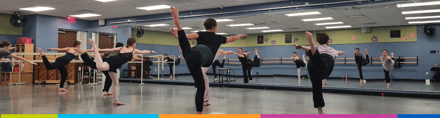 jcc-performing-arts-adult-ballet-class Dancers are practicing ballet positions inside the JCC Performing Arts dance studio.